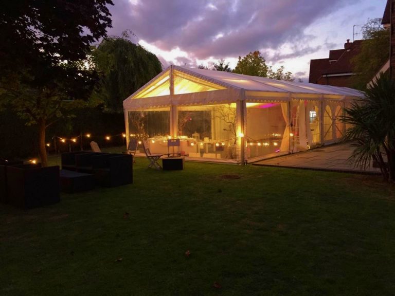 Clear Marquee looking out to a fairy light lit garden surroundings