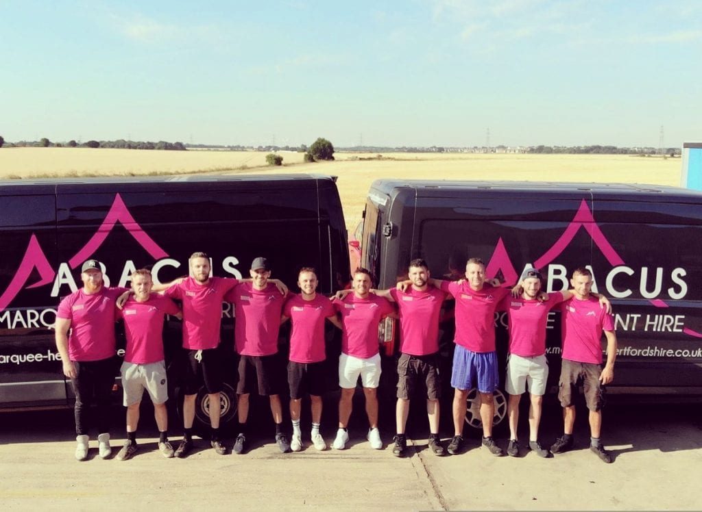 Why Use Us? 1 The Abacus Marquee Hire team stood in front of business branded vans